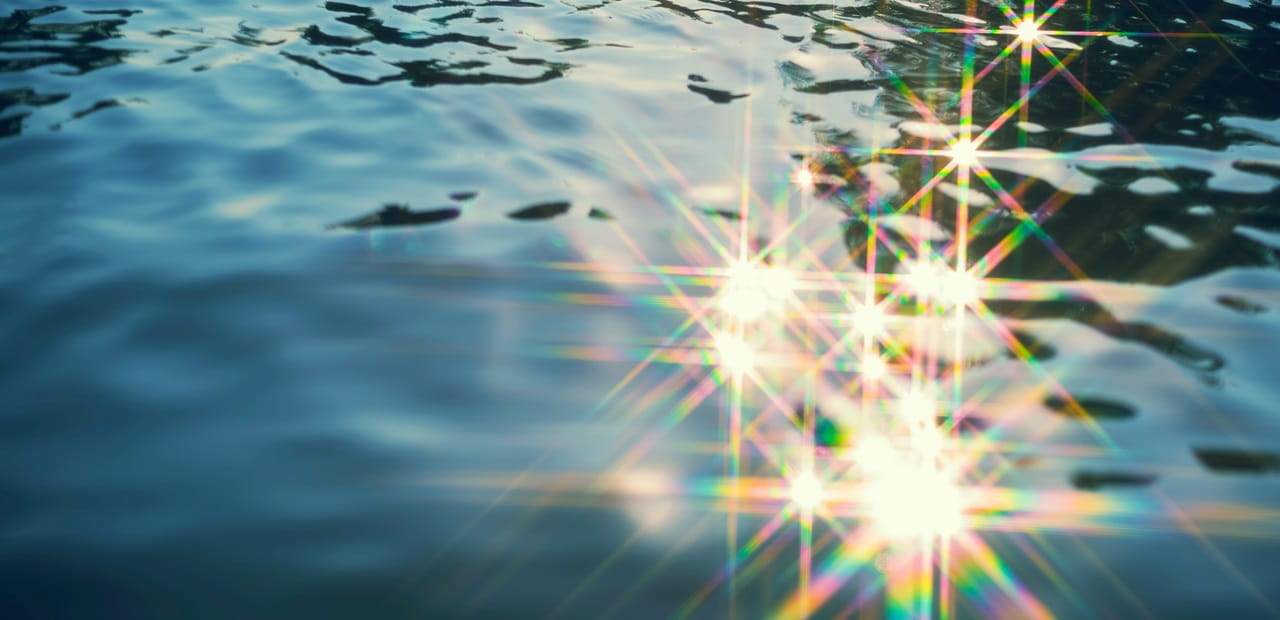 Abstract background from water texture with glitter from reflection of sunlight