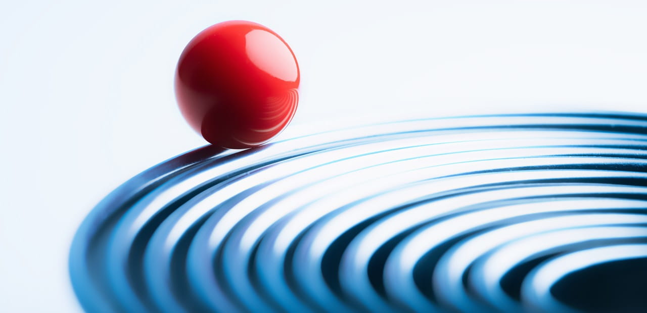 Bright red ball riding on edge of metal rings